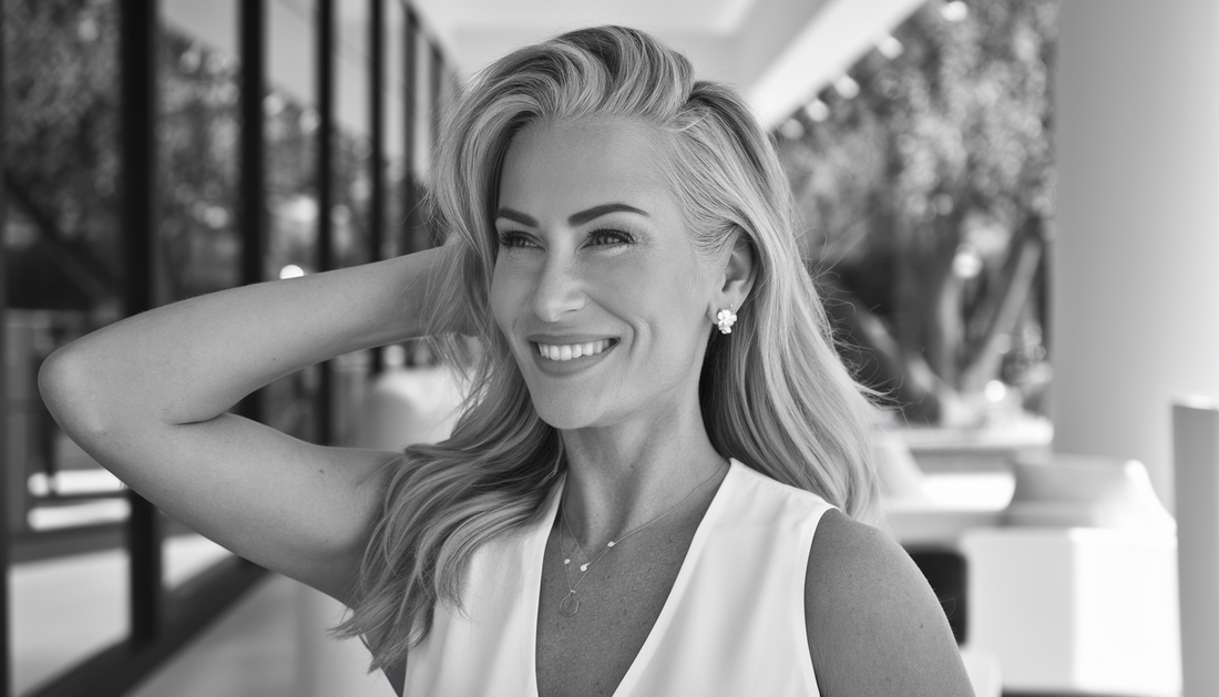 A confident woman with a natural, fuller hairline in a modern Southern California setting, showcasing scalp micropigmentation results.